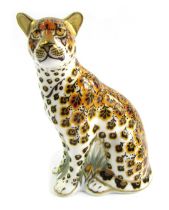 A Royal Crown Derby porcelain paperweight modelled as Leopardess, silver stopper and red printed mar