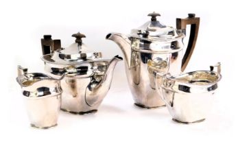 A George V silver four piece tea and coffee service, with brown and ebonised knops and handles, with