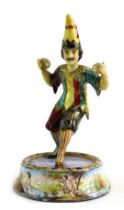 An early 20thC painted tinplate figure of a juggler, mounted on a circular base, hand painted with f