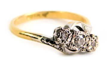 A three stone dress ring, with design of three illusion set tiny diamonds, set in platinum, on twist