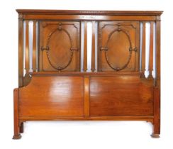 A George V walnut bed head and foot, the headboard with twin quarter veneered panelling, 157cm wide.