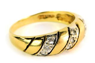 An 18ct gold wedding band, of crossover design, set with three panels of three round brilliant cut d