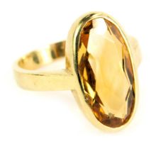 A 9ct gold dress ring, the oval citrine in a rub over setting on plain band, ring size P, 4.7g all i