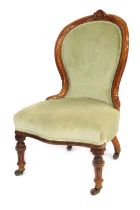 An Edwardian walnut framed spoon back chair, with green Dralon upholstery, on turned legs terminatin