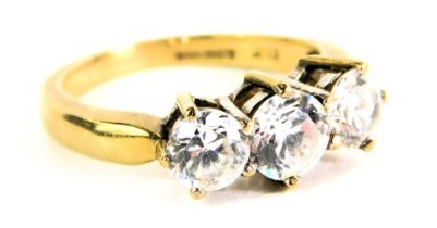 A 9ct gold and CZ set dress ring, the design set with three round brilliant cut cz stones, in claw s