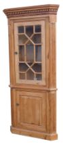 A George III stripped pine corner cabinet, with dentil moulded cornice, astragal glazed door over