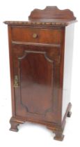 A 20thC mahogany bedside cabinet, the top with a raised back above a gadrooned edge, the base with f
