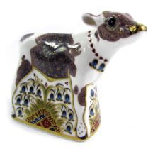 A Royal Crown Derby porcelain paperweight modelled as Bluebell Calf, gold stopper and red printed ma
