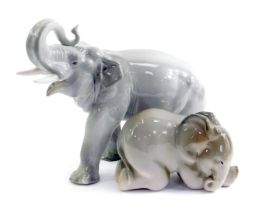Two Russian Lomonosov porcelain elephants, one in standing pose with trunk raised, 20.5cm high, and