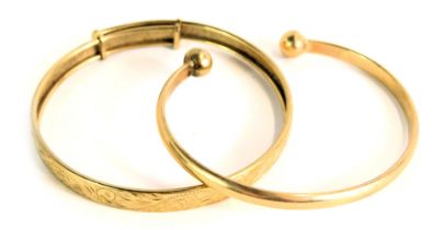 A 9ct gold torc bangle, 16.1g, and an unmarked yellow metal bangle, with sliding scale, 7.9g. (2)