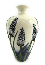 A Moorcroft bud vase, decorated with sprays of flowers in Sweetness pattern, signed to underside, 16