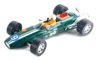 A 1960s green racing car Lotus, with label stamped powered by Ford, 36cm long.