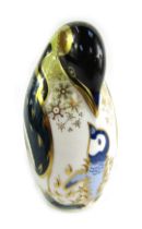 A Royal Crown Derby porcelain paperweight modelled as a penguin and chick, gold stopper and red prin