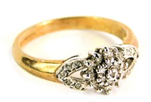 A 9ct gold cz dress ring, the central layered cluster with V splayed shoulders set in platinum, on a