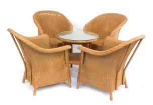 A set of four Lusty Lloyd Loom tub chairs, and a circular table. (5)