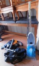 A Vax carpet cleaner, a Samsung vacuum cleaner, and various accessories.