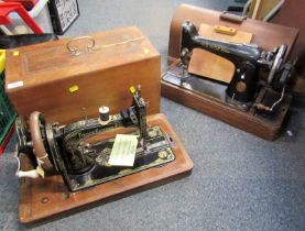 Two cased sewing machines.