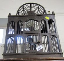 A wooden bird cage, containing plastic bird, 43cm high.