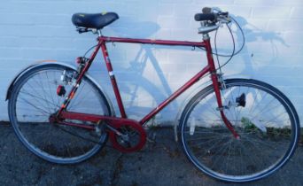 A Hercules bicycle, in red trim.