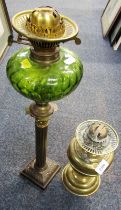 A brass oil lamp, Corinthian column, green glass central reservoir, lacking shade and chimney, 51cm