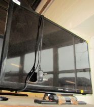 A Samsung 27" television, UE28J4100AKXXU, with lead and remote.