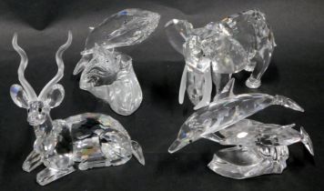 Four Swarovski crystal animal ornaments, comprising two dolphins riding wave, two whales riding wave