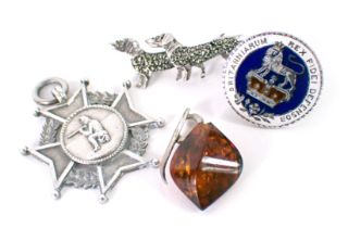 A silver shield fob, a dachshund brooch set with marcasite stamped silver, an enamelled coin cuff li