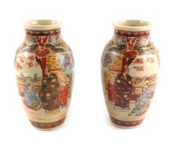 A pair of Japanese earthernware vases, each on a cream ground decorated in orange and brown, with fi