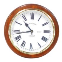 An AF Wilson replica circular oak cased railway wall clock, the dial bearing Roman numerals, and L.D