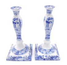 A pair of Spode Italian blue and white candlesticks, decorated with animals, figures and buildings,