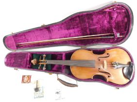 An early 20thC violin, with a two piece back, with turned ebony pegs, possibly German, 61cm long, an