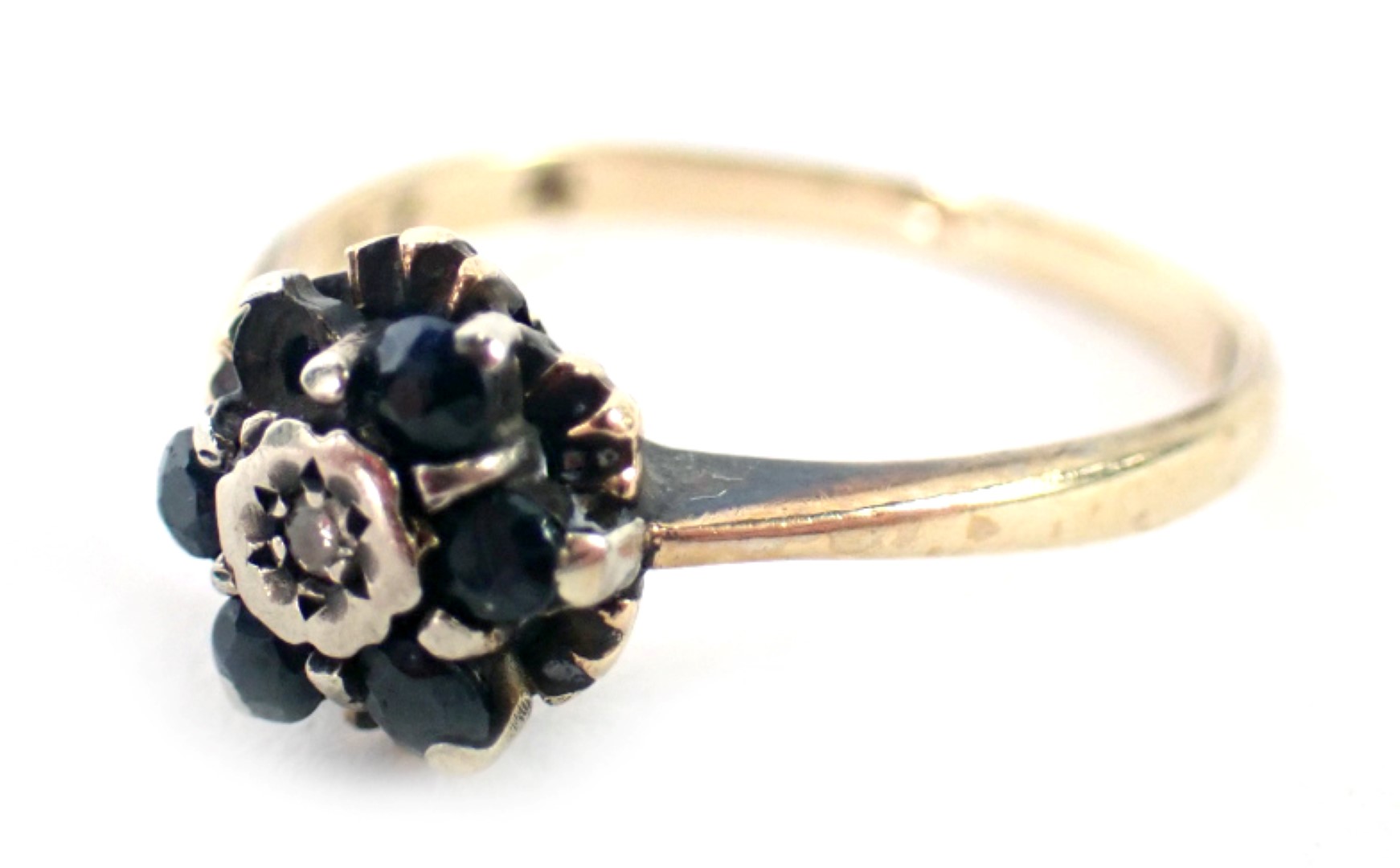 A 9ct gold dress ring, set with sapphire and diamond in a floral cluster, one stone missing, ring si