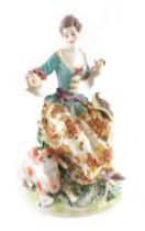 A French Derby porcelain style female figure, wearing a bonnet and beside a sheep, possibly Samson,