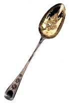 A 19thc silver berry spoon, the bowl gilded with hammered decoration of roses, and fiddle pattern ou