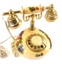 An Astral Telecoms telephone, with fruits and flowers cream design, with raised gold coloured suppor