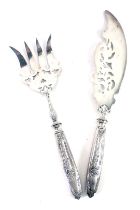 A pair of 19thC fish servers, each with stainless steel blade, on white metal handles, with bow and