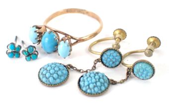 A turquoise jewellery suite, comprising a pair of drop earrings, stud earrings, and a three stone dr