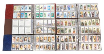 A quantity of cigarette card albums, to include Dogs, Inns and Towns, Kensitas Silk Flag cigarette c