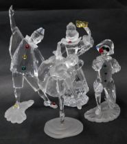 Four Swarovski crystal figures, comprising 00GS, Melt Harlequin GIA11, ballerina, and gentleman with