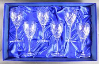 A set of six cased Royal Doulton wine glasses.