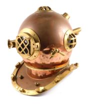 A reproduction copper and brass diving helmet, 41cm high.