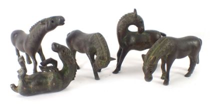 Five bronze patinated Chinese horse figures, in varying positions, 6cm high.