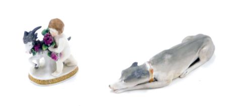 A continental porcelain bisque greyhound, and a goat and putto figure. (2)