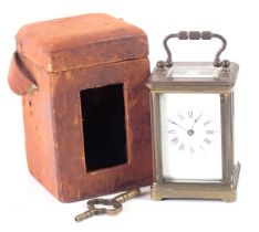 A 20thC brass cased miniature carriage time piece, in red leather outer travel case, with brass casi