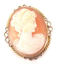 A 9ct gold framed shell cameo brooch, depicting maiden in twist and scroll outer border, 2.5cm x 2cm
