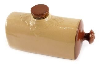 A stoneware hot water bottle, on a light and dark brown ground, 26cm wide.