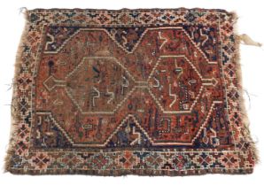 A Turkish design rug, with two medallions, on a central red field, 115cm x 155cm.