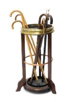 An early 20thC mahogany brass and copper banded umbrella stand, or stick stand, and various walking