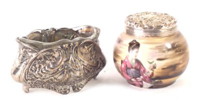 Two white metal trinkets, comprising a ceramic transfer printed and decorated pot with geisha, with