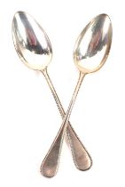 A pair of continental white metal spoons, each with a beaded edge, stamped 800TS, 3.31oz.